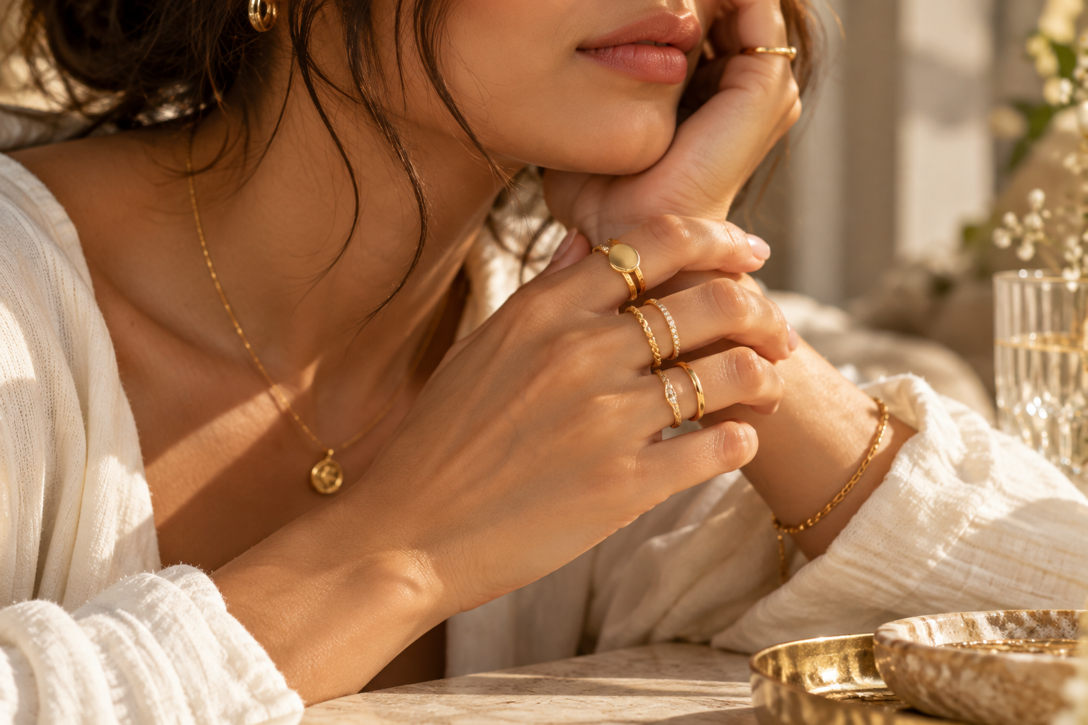 A woman wearing a considered everyday stack of gold rings
